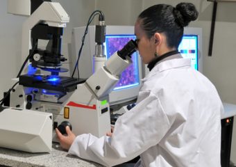 researcher working with fluorescent microscope