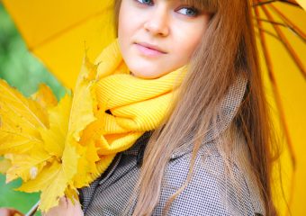 Beautiful young woman with a yellow umbrella